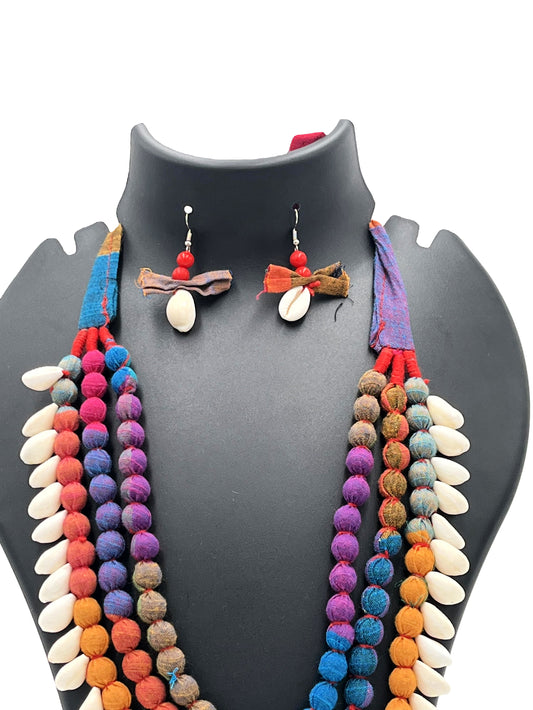 Colorful necklace and earrings set on a mannequin bust against a white background