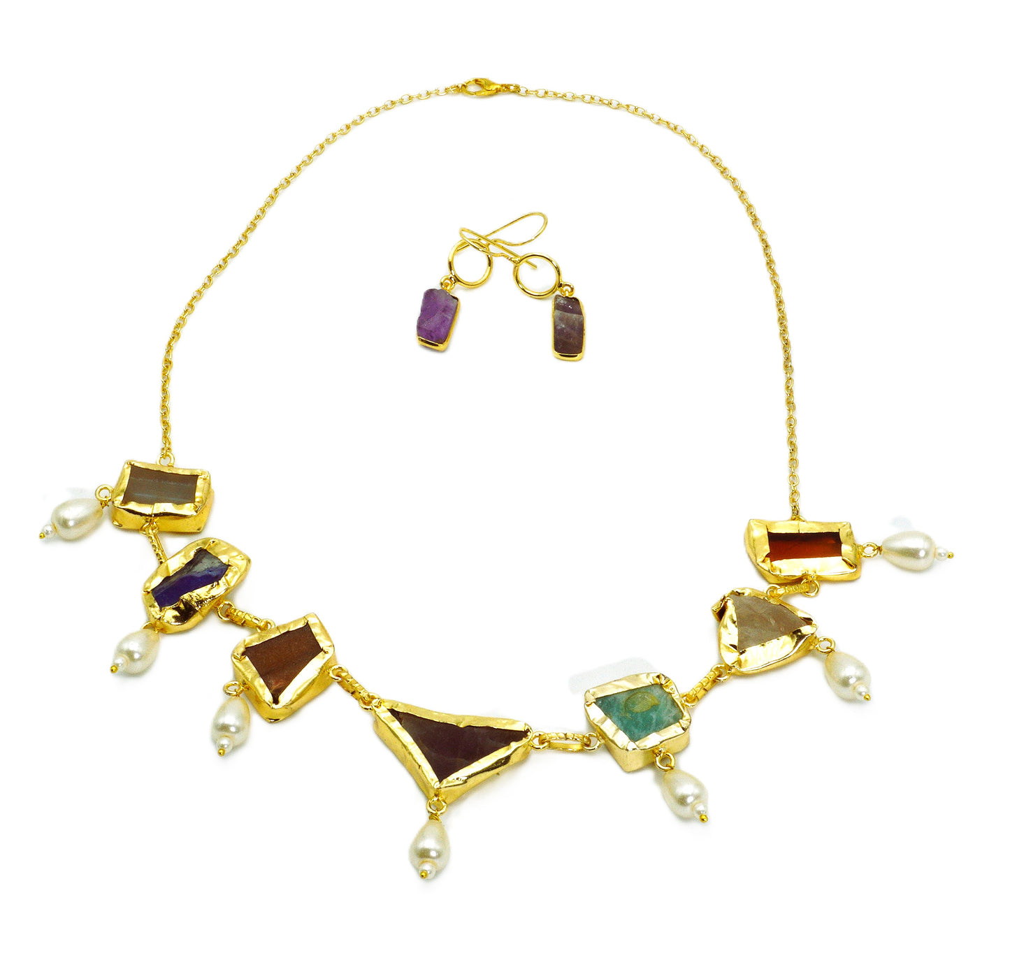 Gold necklace with gemstones and pearls on a white background