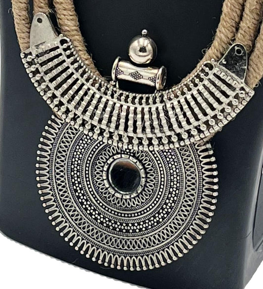 Close-up of oxidised silver tribal pendant with jute thread – The Chakmak