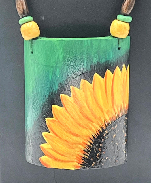 Close-up of sunflower pendant on handcrafted bamboo jewelry – The Chakmak