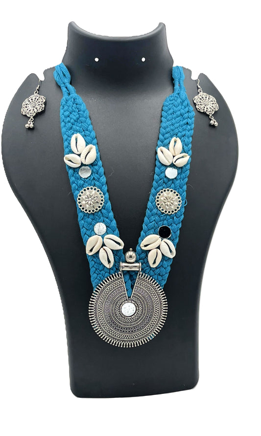 Handcrafted teal blue thread necklace set with cowrie shells and oxidized round tribal pendant – The Chakmak Rang Tarang Collection