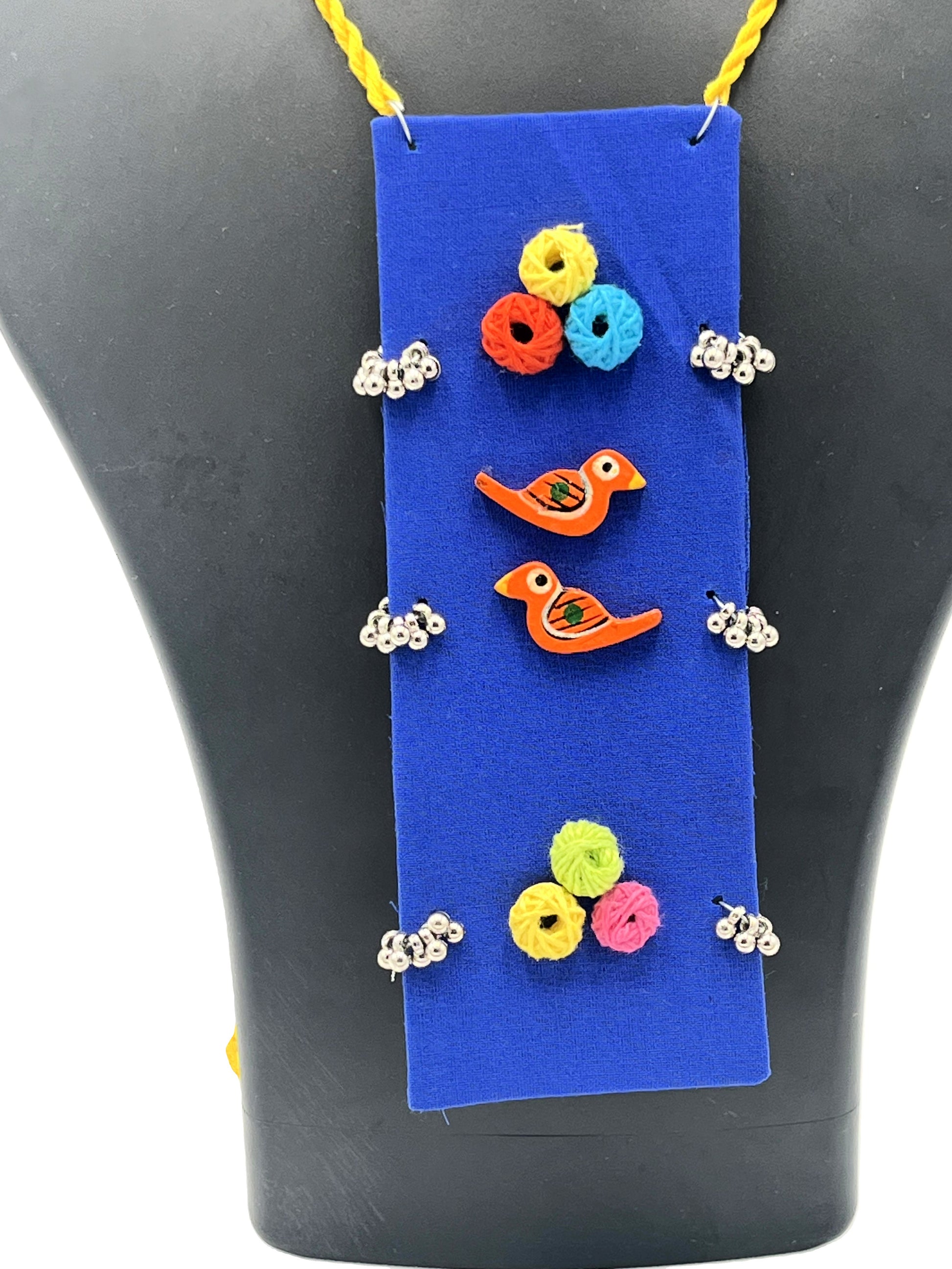 Close-up of Artistic Bird Motif with Yarn Beads on Indigo Necklace