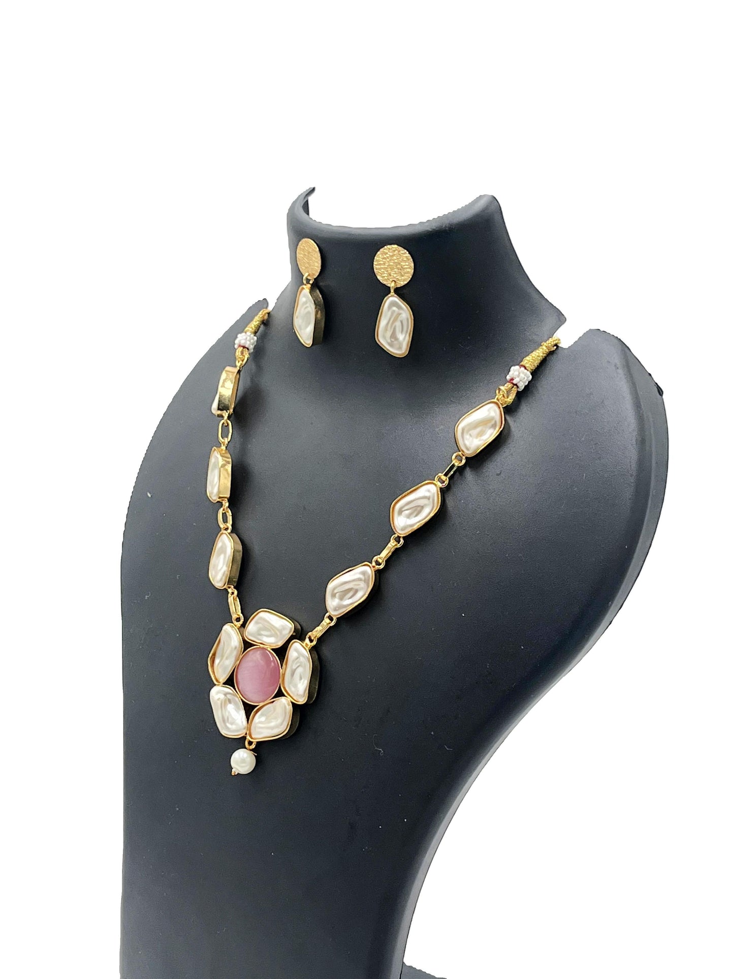 Jewelry set with necklace and earrings on a black mannequin bust