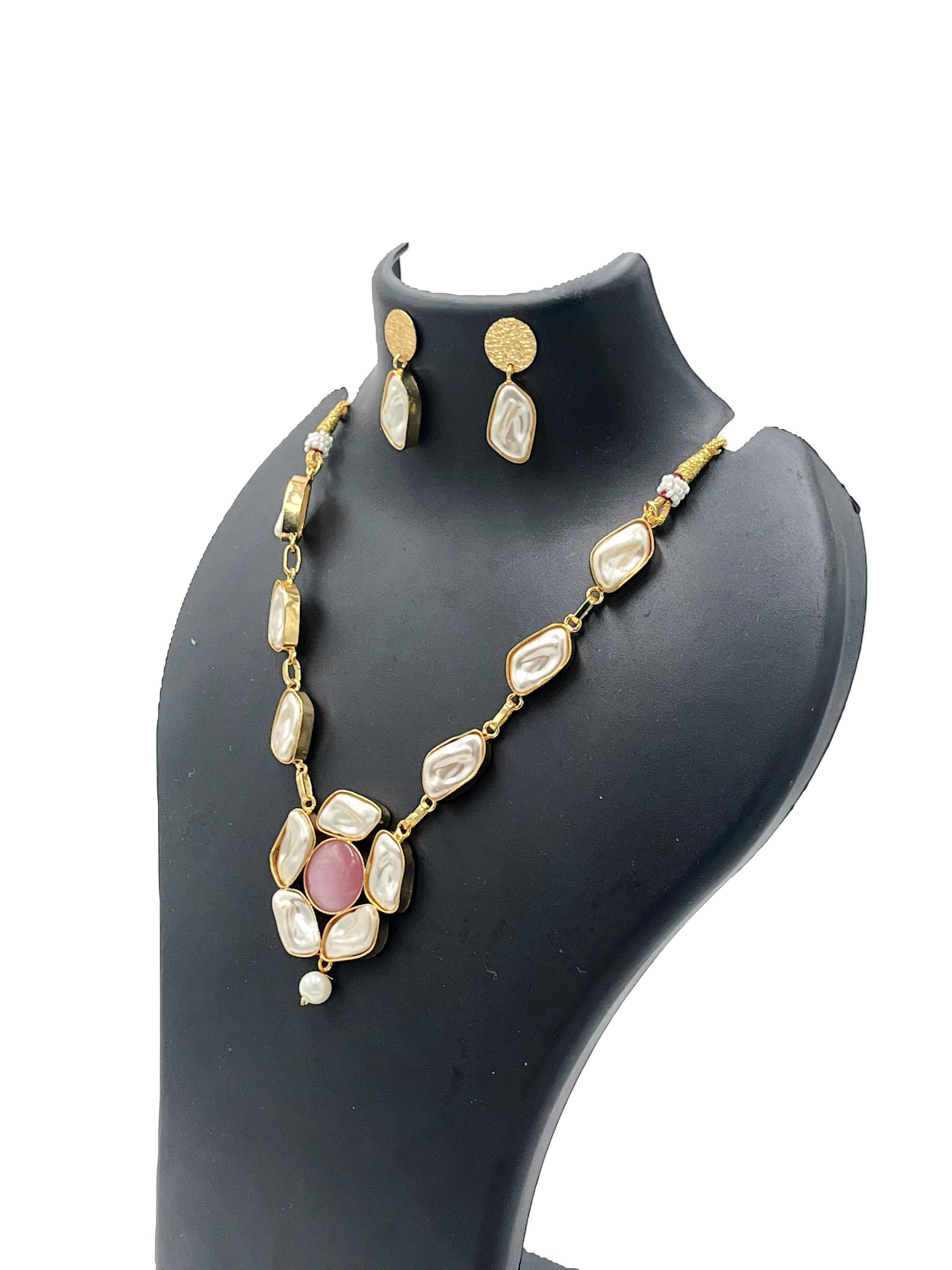 Jewelry set with necklace and earrings on a black mannequin bust