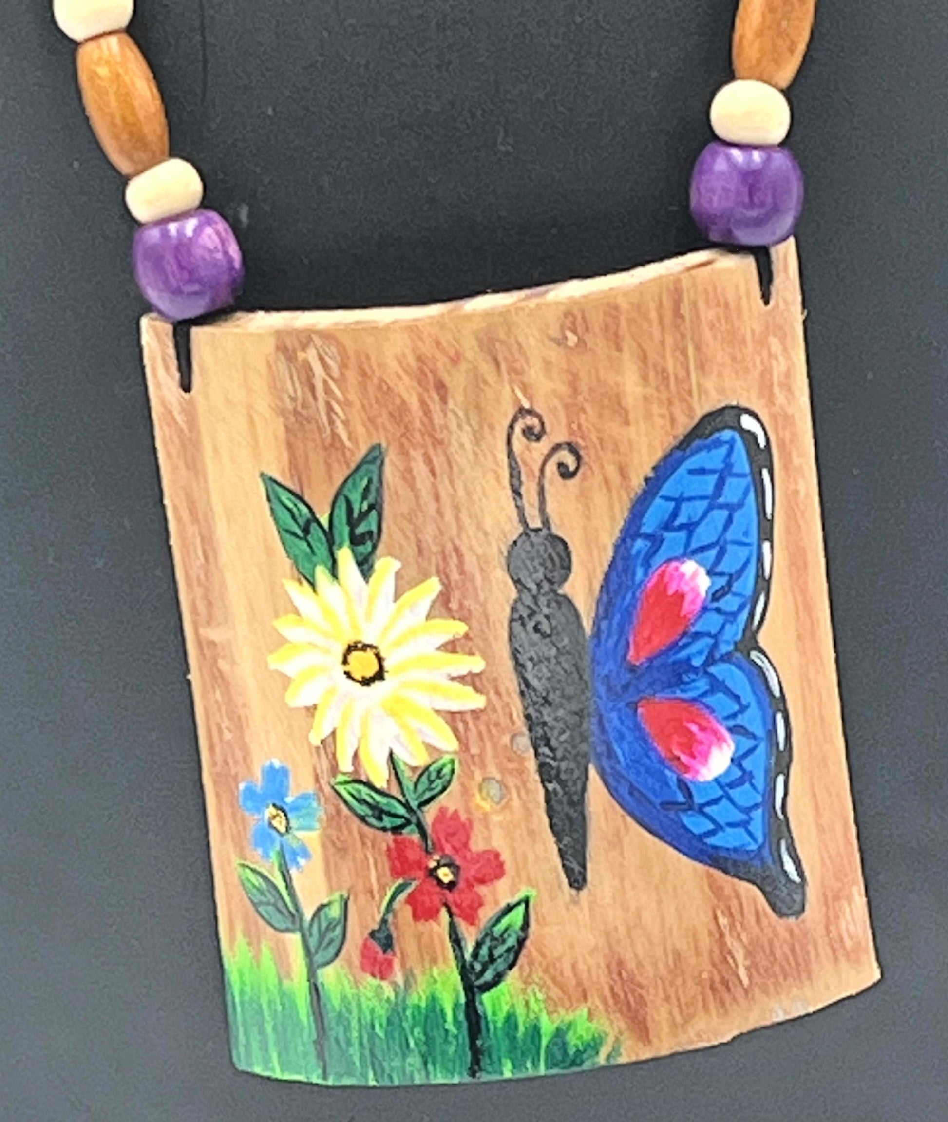 Close-up of Handcrafted Bamboo Pendant with Butterfly & Floral Design – The Chakmak
