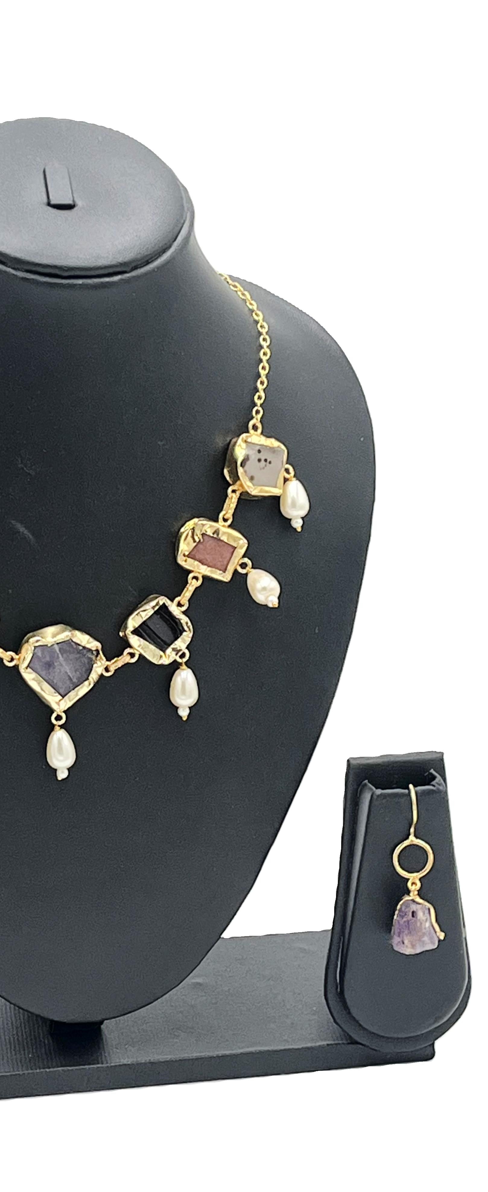 Gold Plated Natural Stone necklace with gemstones on a black mannequin bust