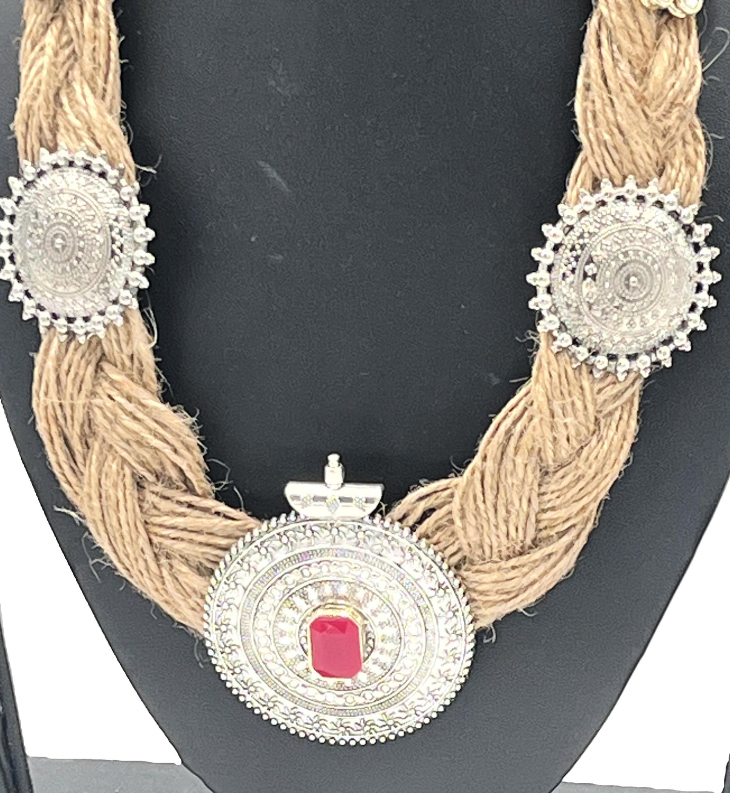 Side view of braided jute necklace with silver motifs and red centrepiece – The Chakmak