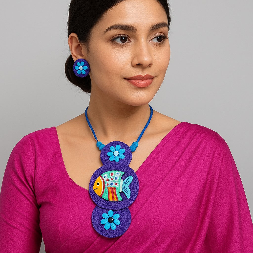 Model wearing handmade terracotta fish necklace with matching earrings