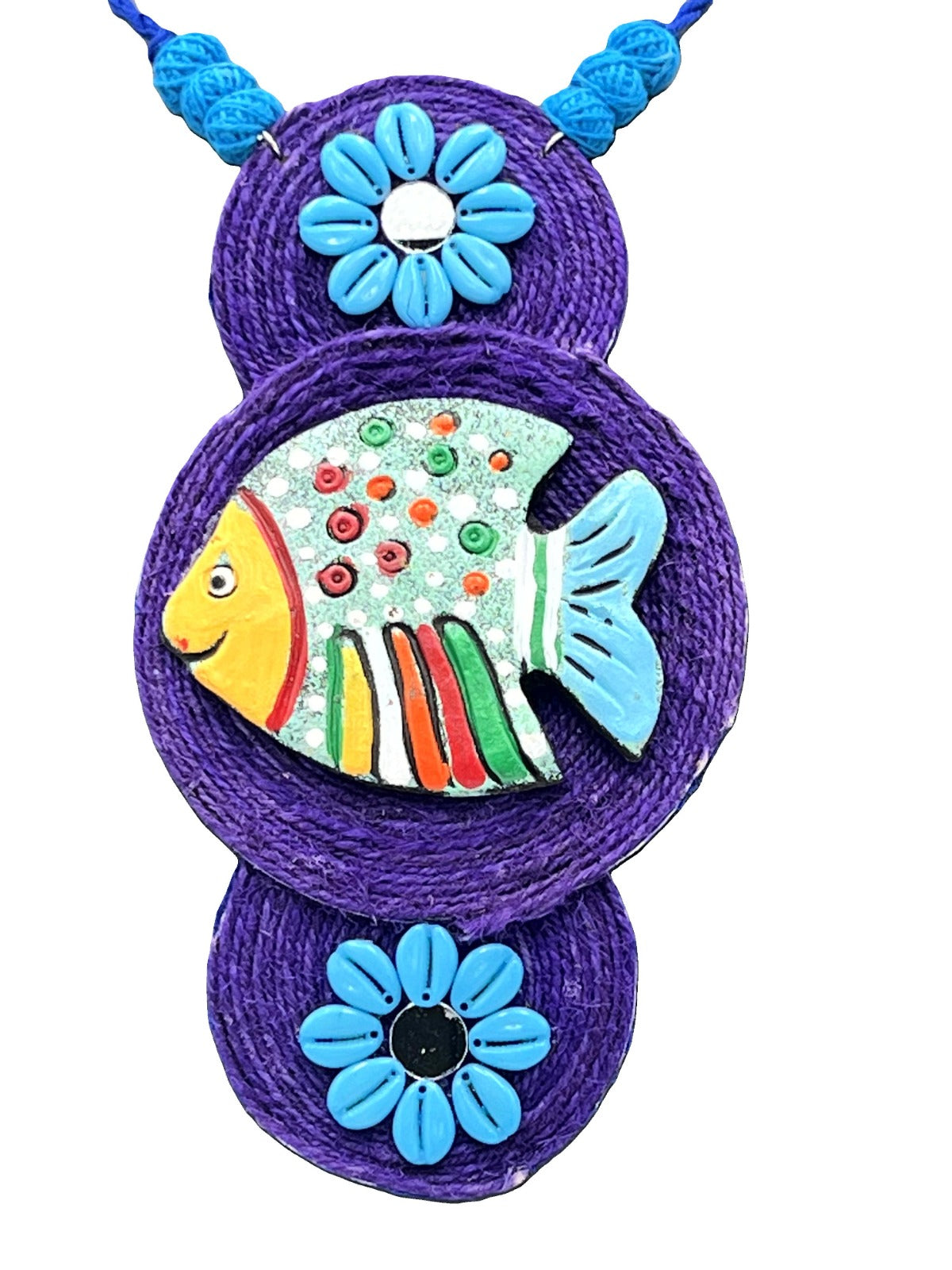Close-up of hand-painted fish pendant on terracotta necklace – ethnic jewelry
