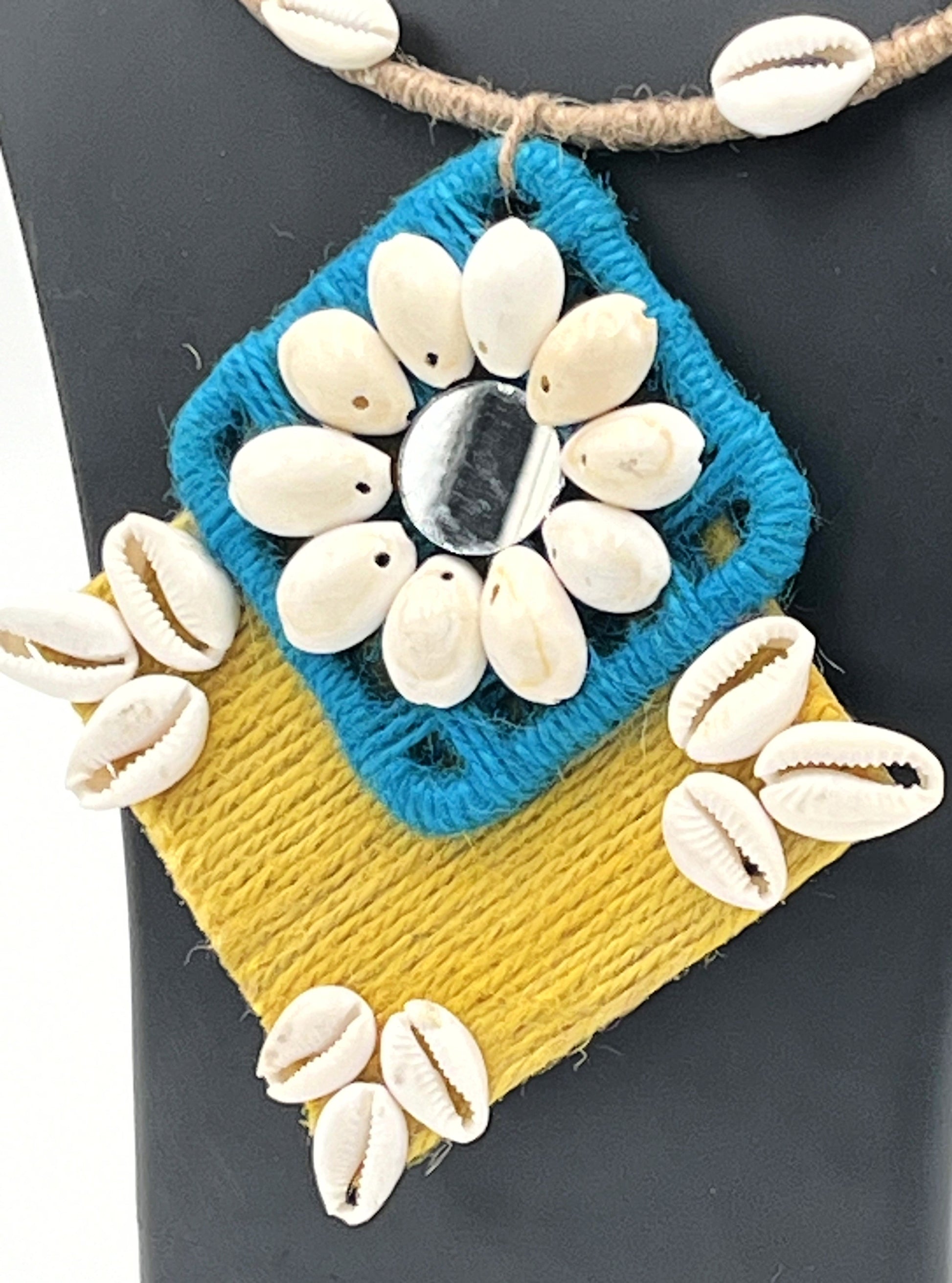Close-up of Blue & Mustard Cowrie Shell Pendant with Jute Craft – The Chakmak