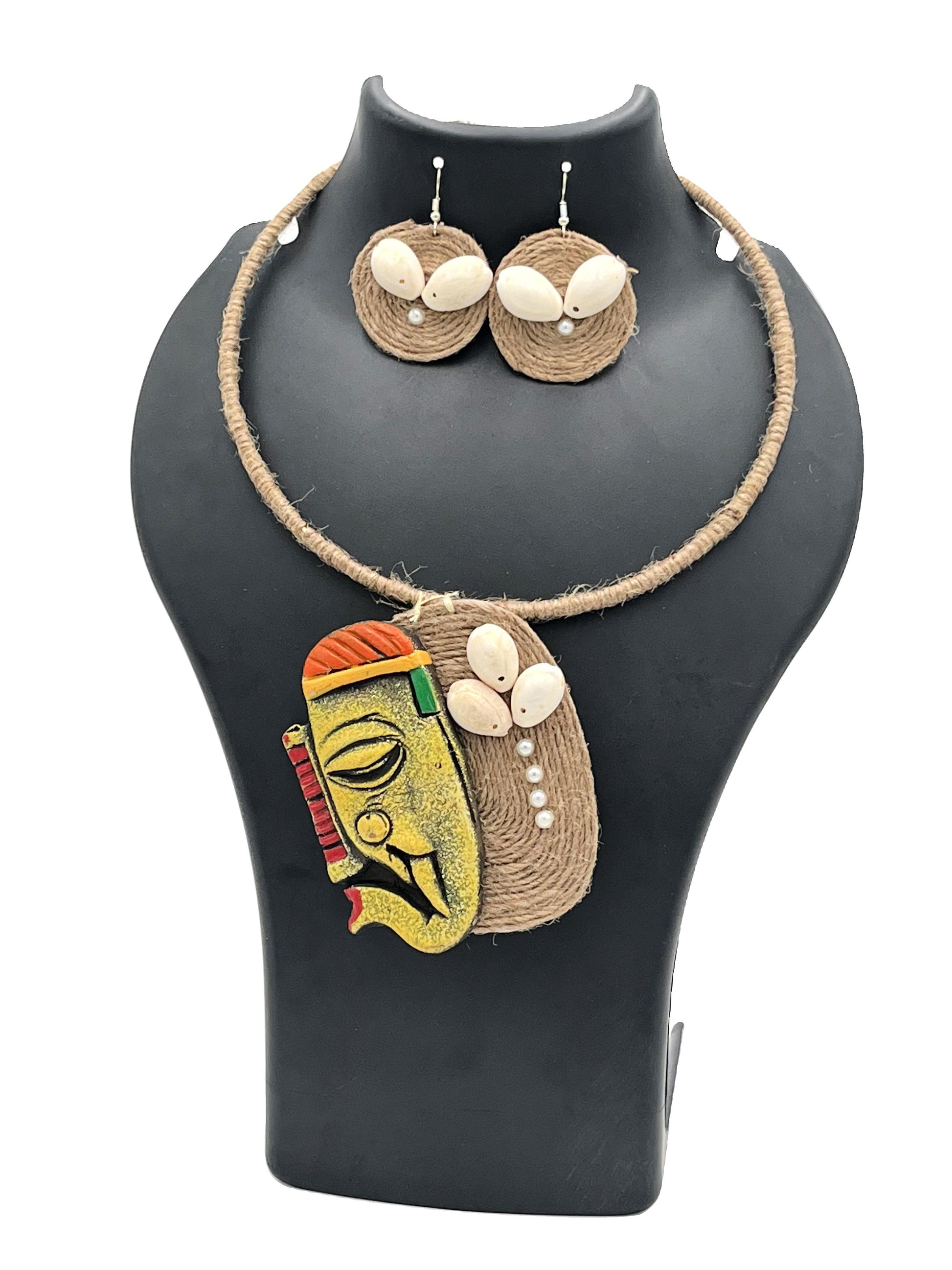 Jewelry set with a necklace and earrings on a black mannequin bust.